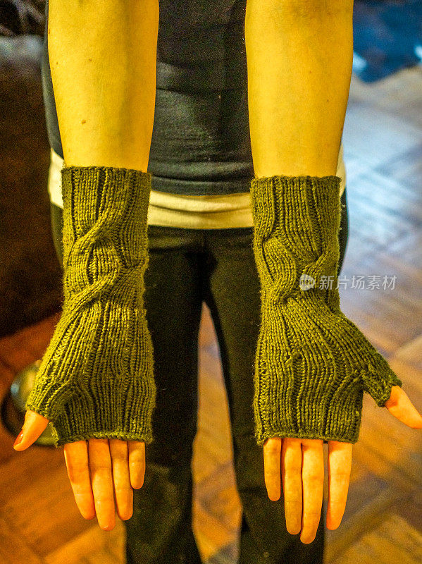 Wearing knit fingerless gloves